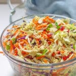 A clear serving bowl filled with ramen noodle salad.