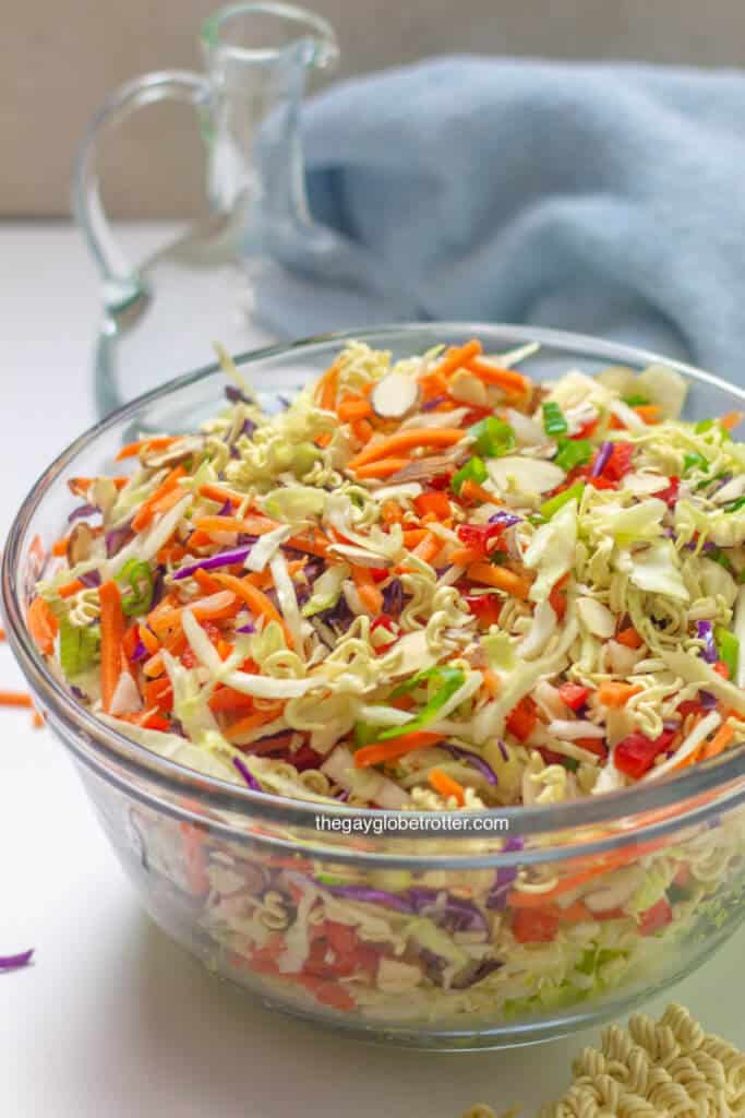 A clear serving bowl filled with ramen noodle salad.