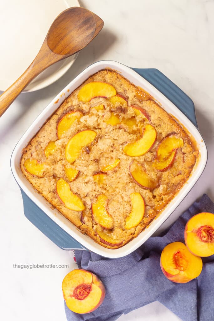 Bisquick peach cobbler in a casserole dish fresh from the oven.