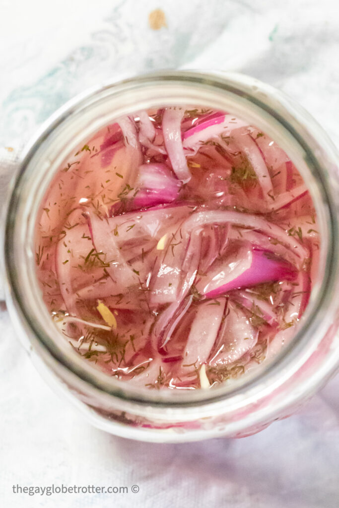 Pickled red onions in a jar.