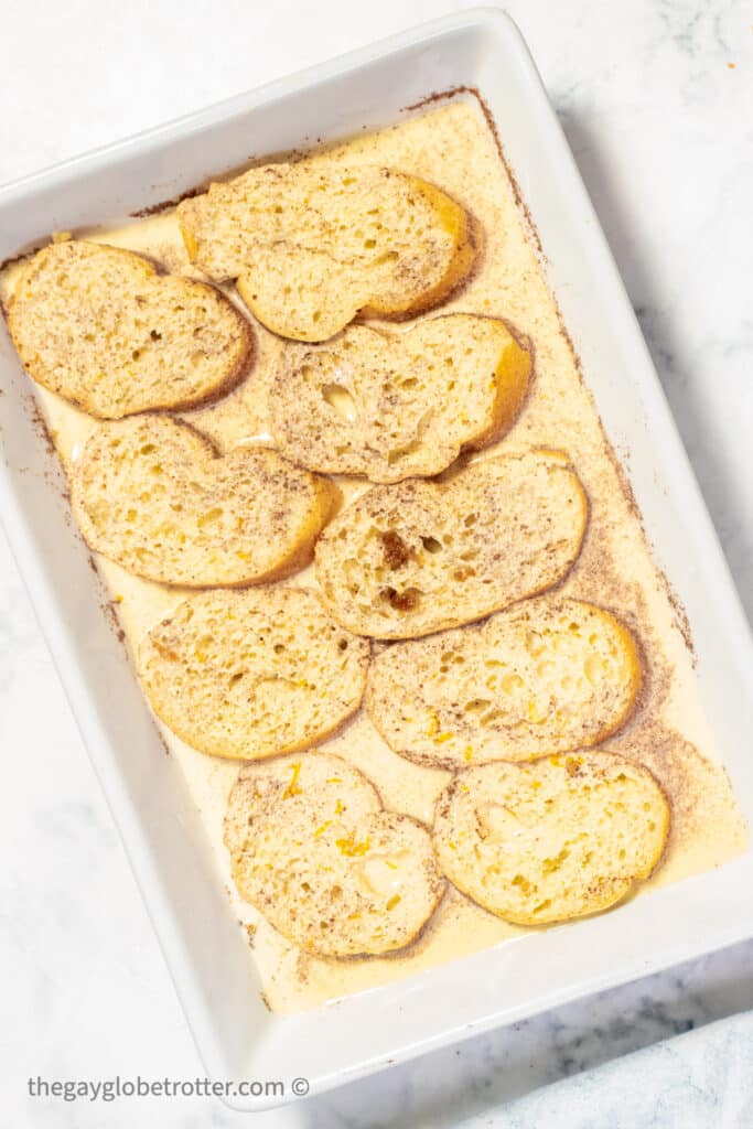 Baguettes covered in egg batter ready to soak.