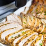 Chicken breast sliced on a serving tray.