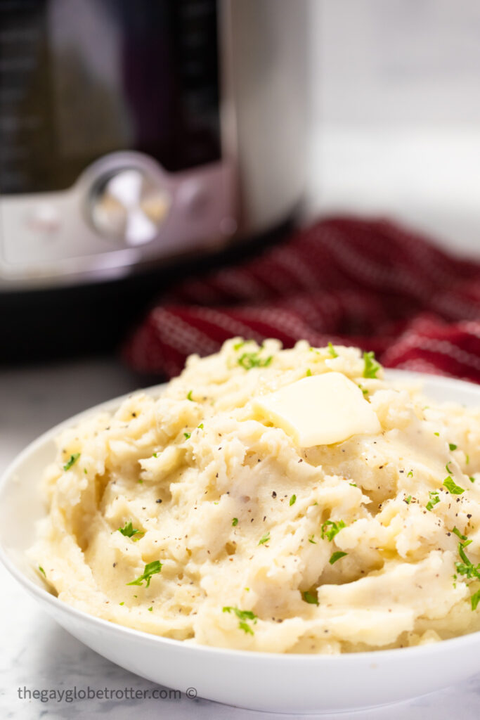 A serving bowl of Instant Pot garlic mashed potatoes.